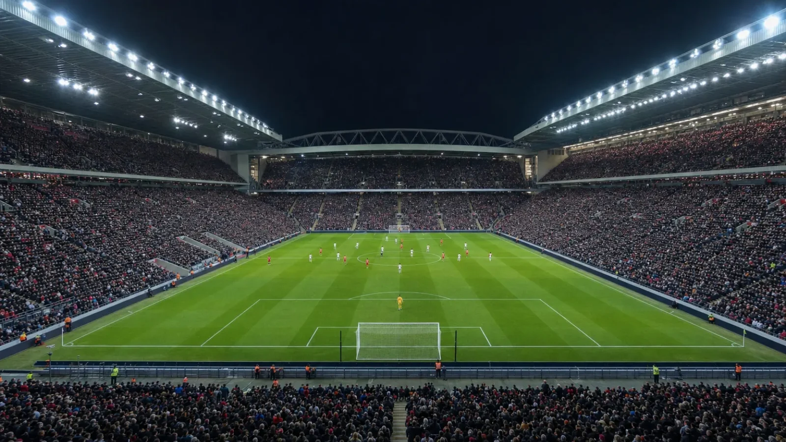 Flutlichtmast über einem gefüllten Stadion bei Nacht